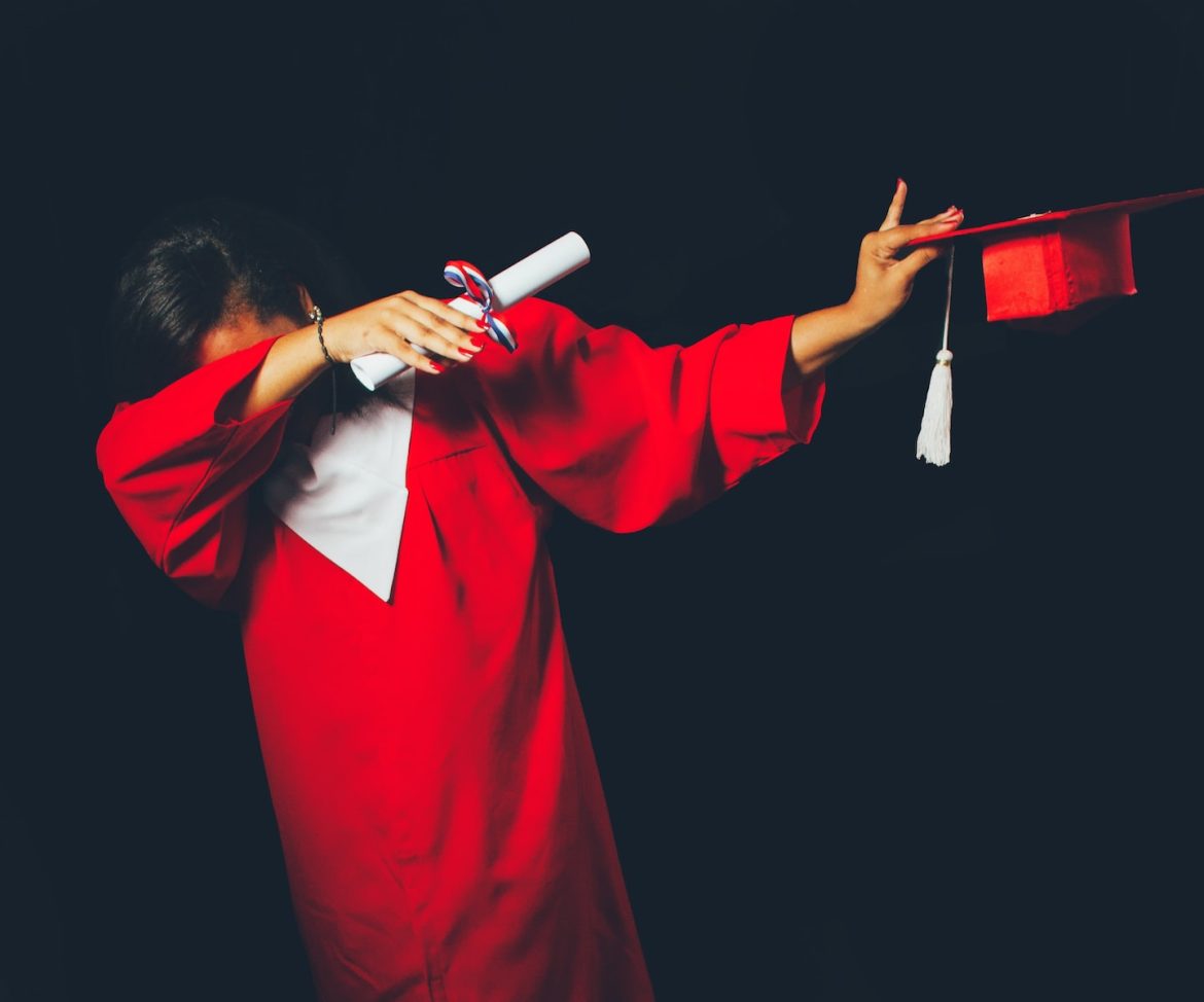 Photo by Honey Yanibel Minaya Cruz person wearing red graduation dress