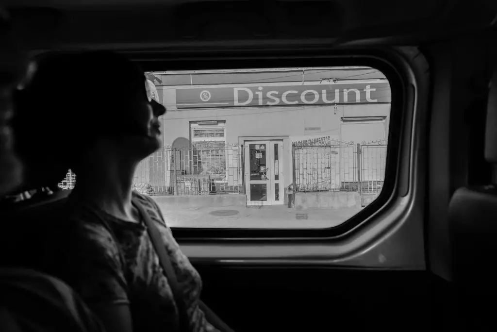 greyscale photography of woman inside vehicle-discount

