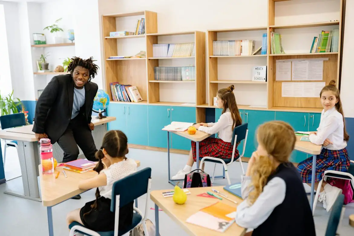 Photo by Yan Krukau Teacher engaging students in a bright classroom, fostering interactive learning.