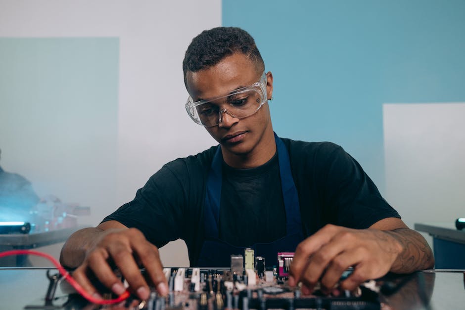 A skilled electrical engineer working on a circuit board.